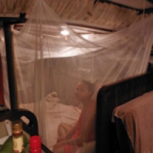 Melissa in her cabin under a mosquito netting- just in case